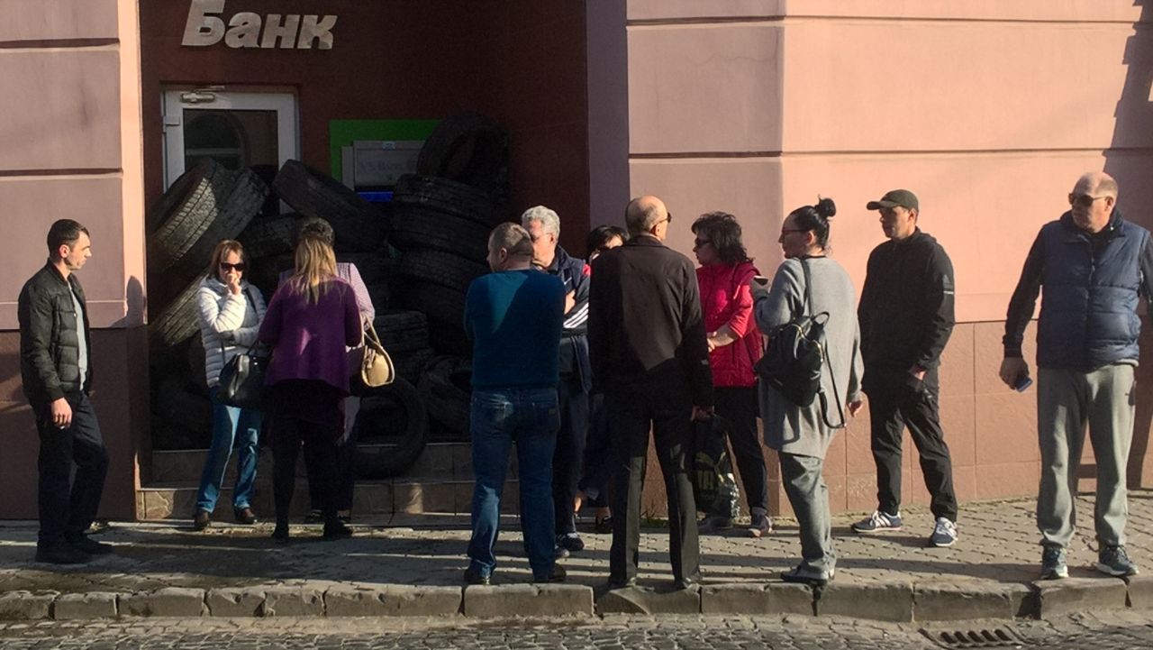 У Мукачеві з вимогою повернути кошти вкладники забарикадували шинами вхід до банку (ФОТО)